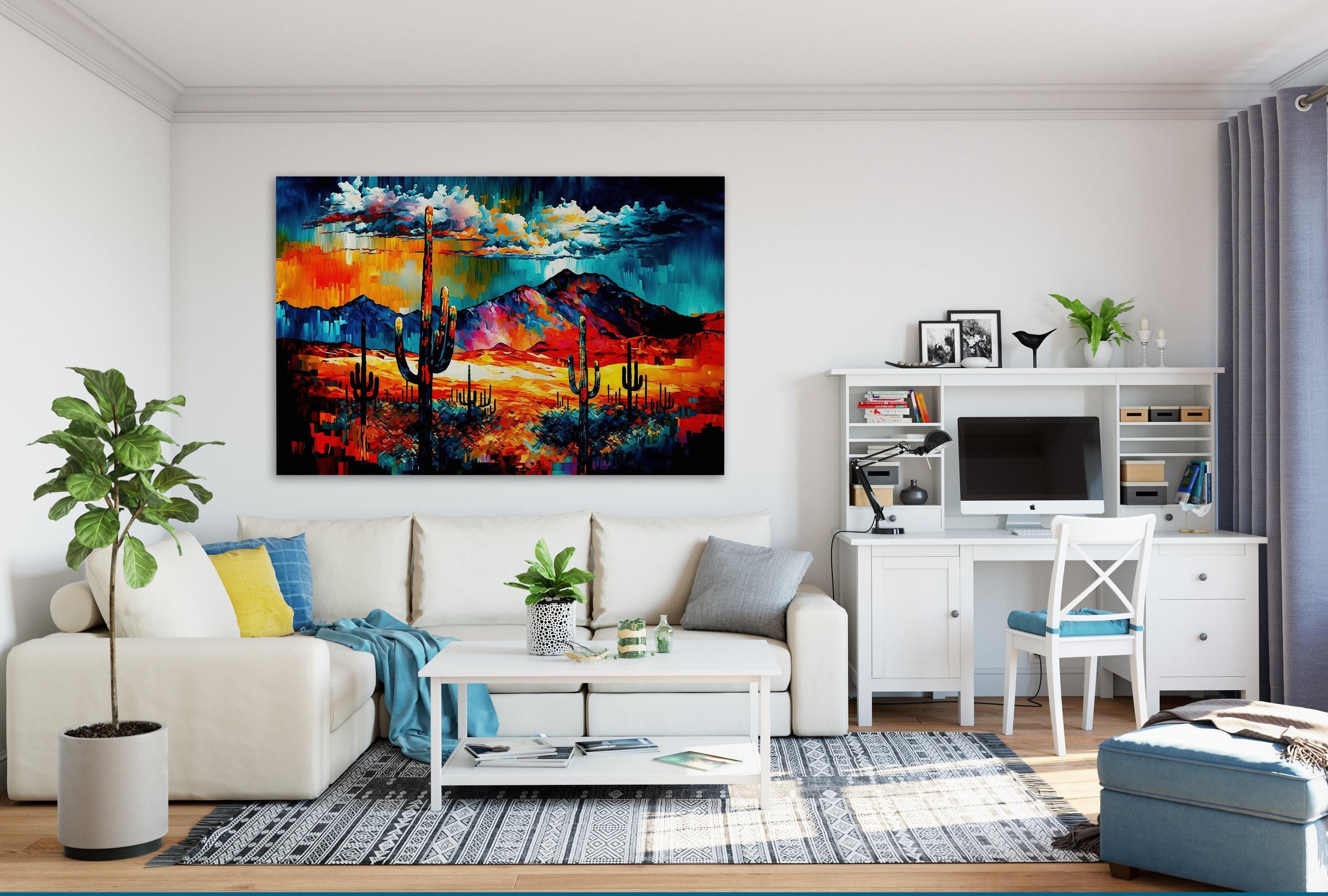 a modern living room with a large, colorful painting of a desert landscape hanging on the wall. The room is furnished with a white sofa, a coffee table, and a desk with a computer setup. The room also features a large window, plants, and decorative elements that create a cozy and inviting atmosphere.