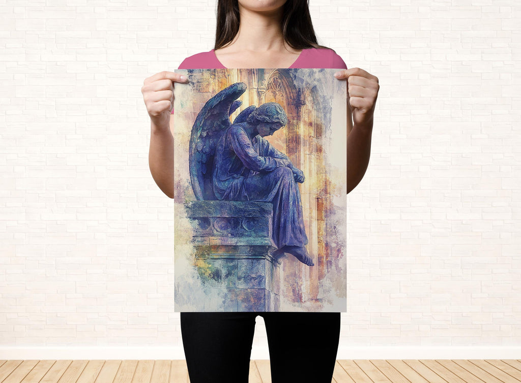 A woman holds up a framed print of an angel statue, which is depicted in a serene and contemplative pose.