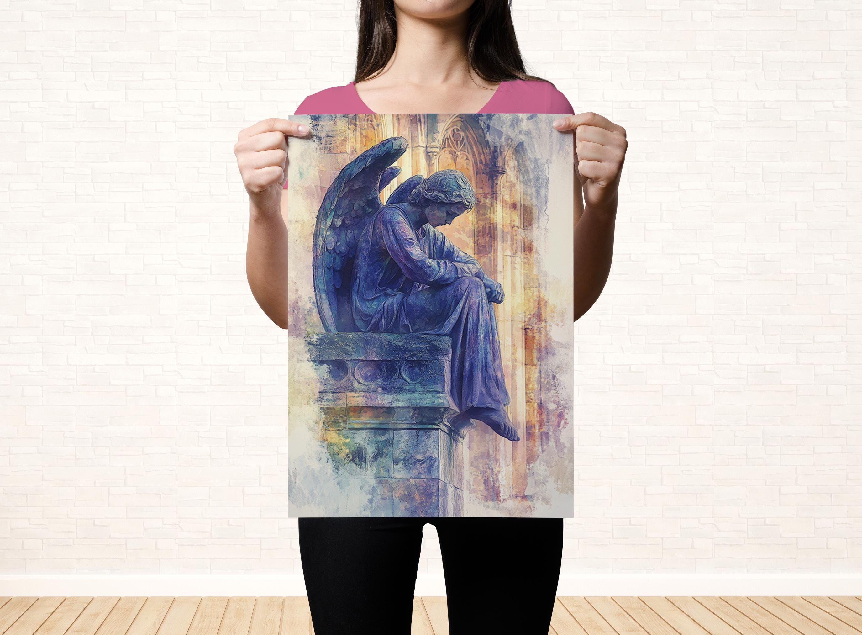 A woman holds up a framed print of an angel statue, which is depicted in a serene and contemplative pose.