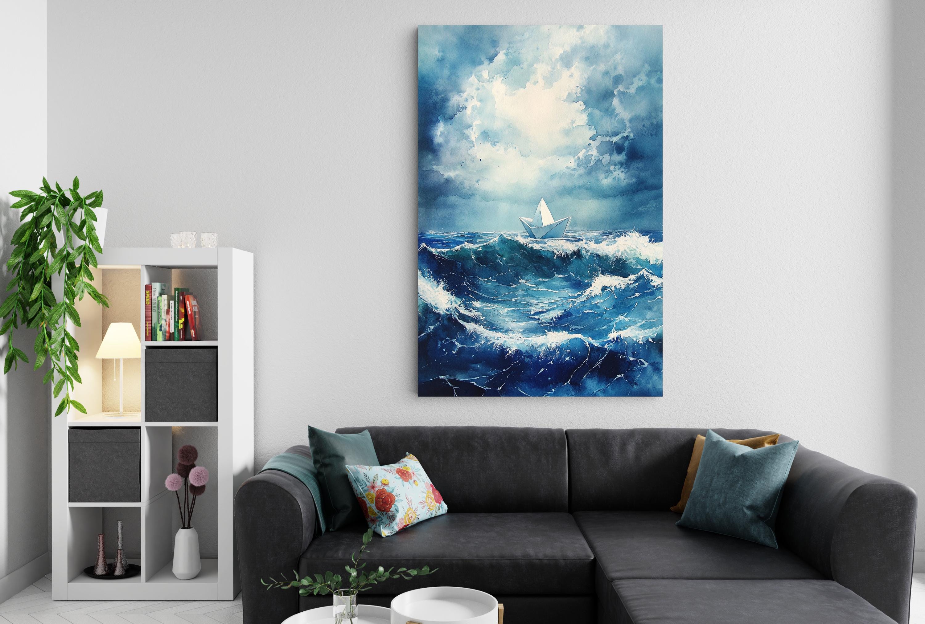 a living room with a gray sectional sofa, a bookshelf, and a large painting of a stormy ocean scene hanging on the wall.