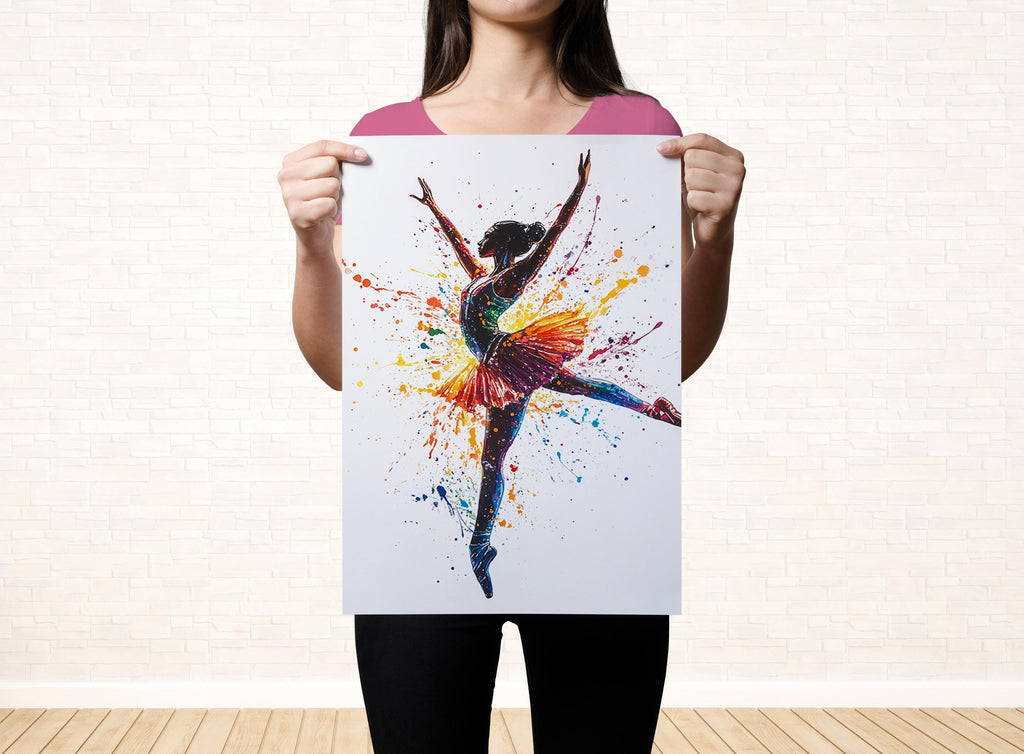 A woman is holding up a colorful painting of a ballerina with her arms raised, against a white brick wall background.