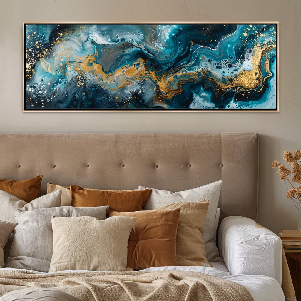 a bed with a large painting hanging above it