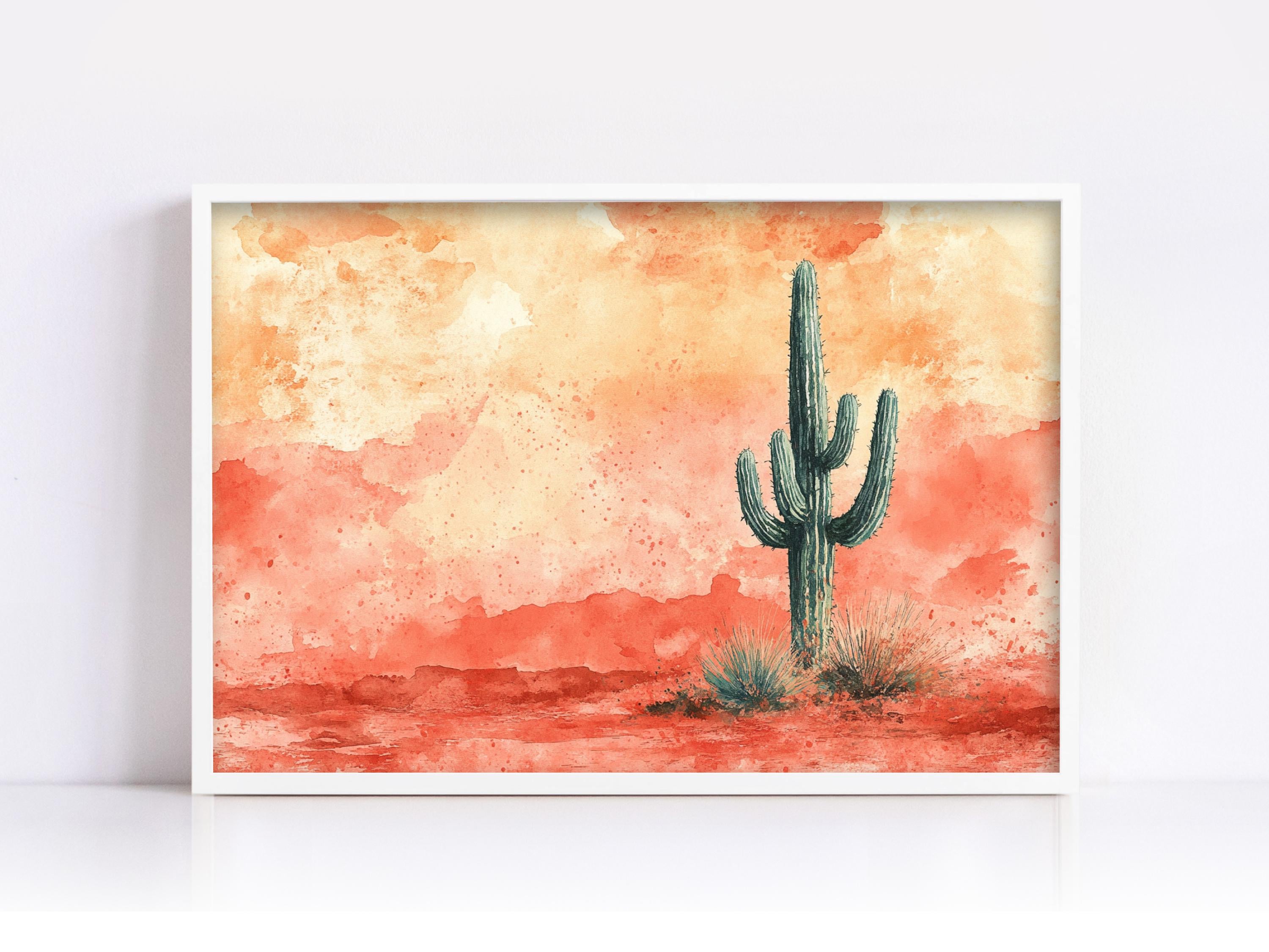 A framed watercolor painting depicting a cactus in a desert landscape with a warm, orange and red background.