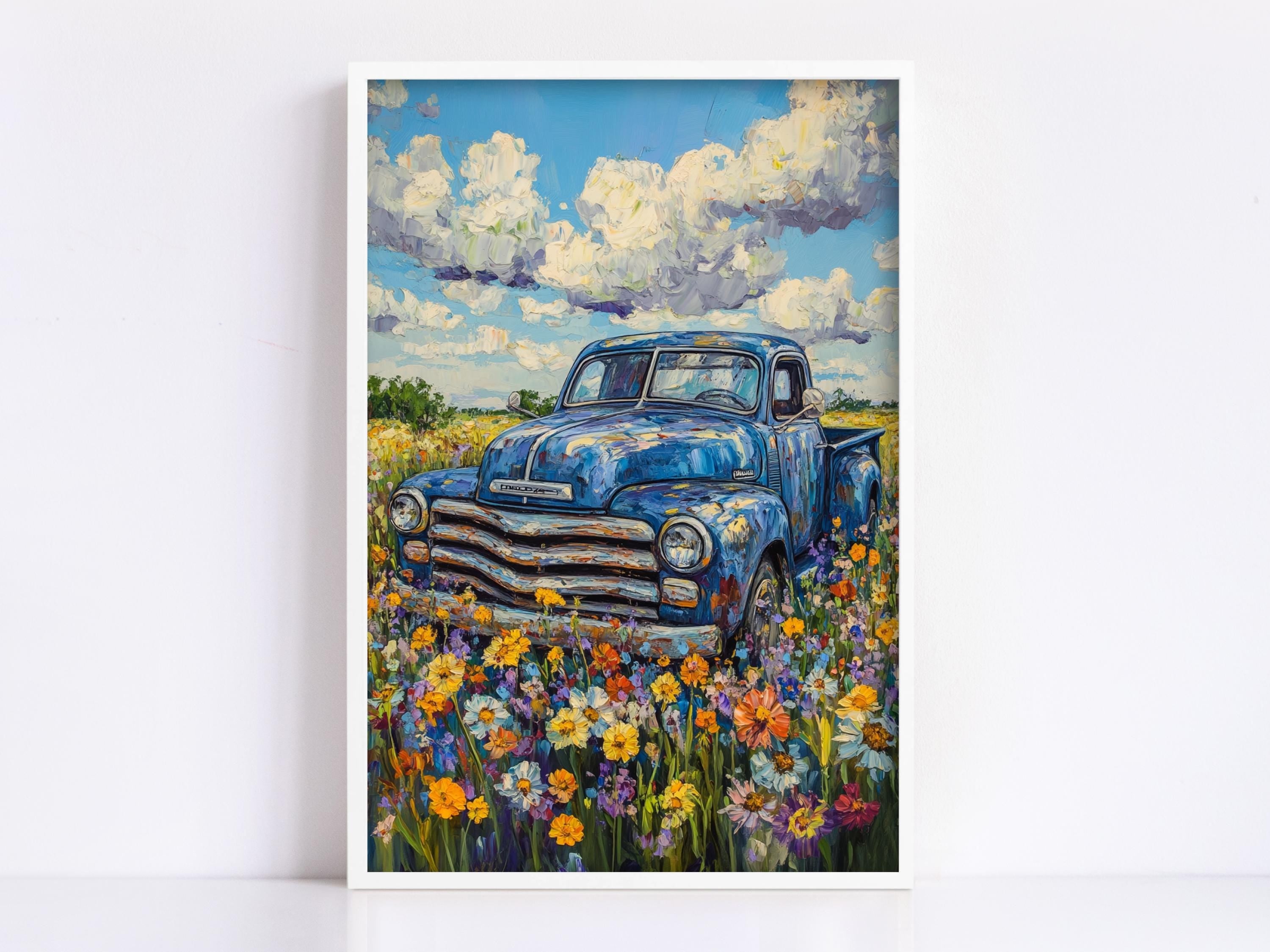 The image is a painting of an old blue pickup truck parked in a field of colorful wildflowers.