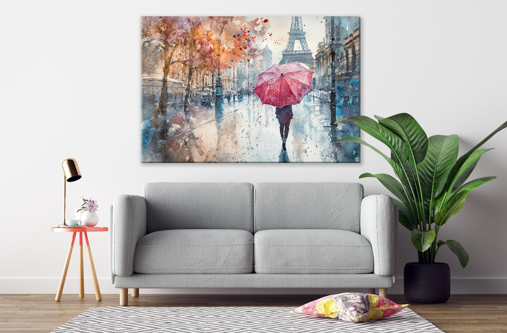 a gray sofa, a potted plant, a lamp, and a large painting depicting a person walking with a red umbrella in front of the Eiffel Tower.