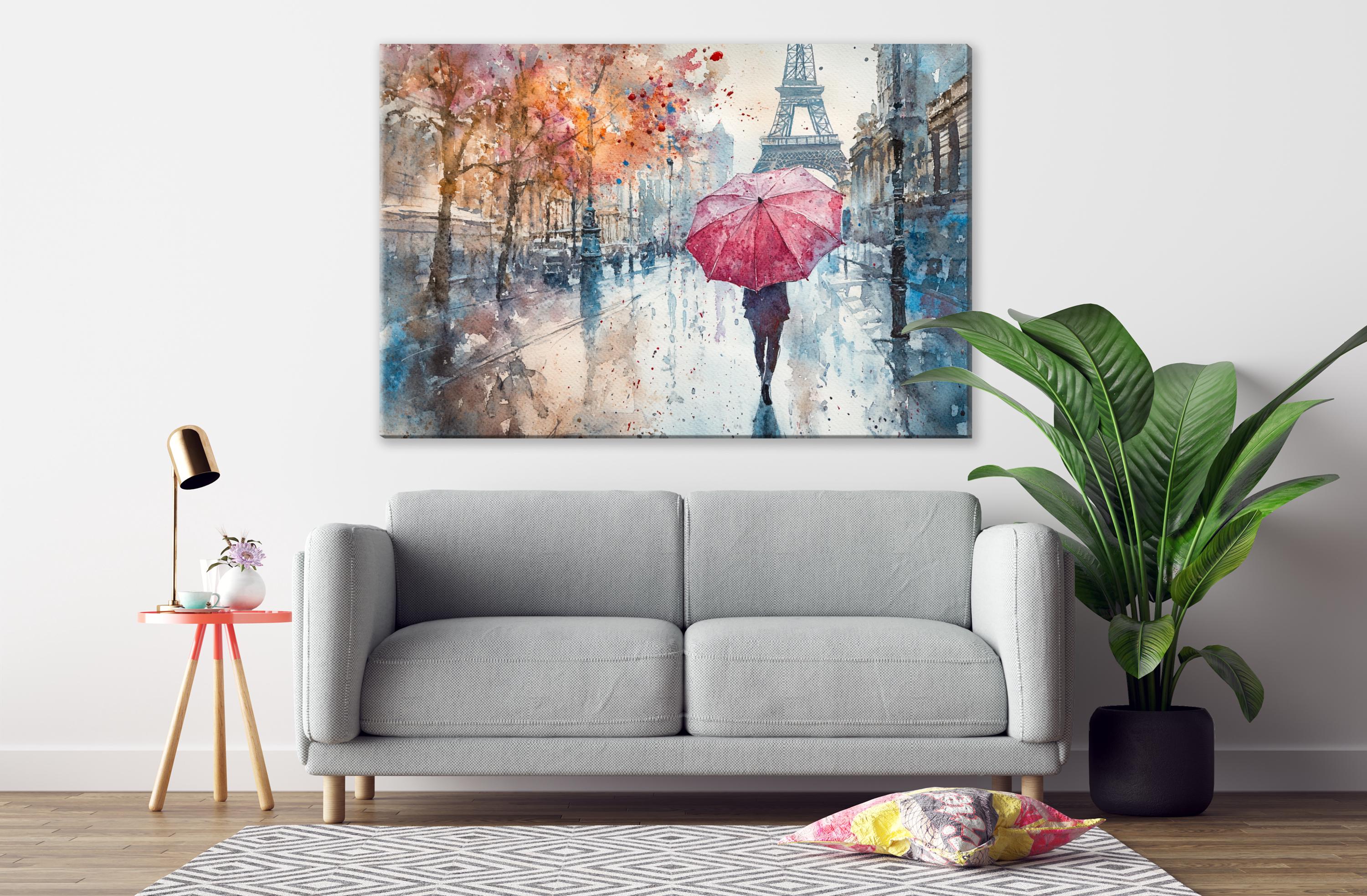 a gray sofa, a potted plant, a lamp, and a large painting depicting a person walking with a red umbrella in front of the Eiffel Tower.