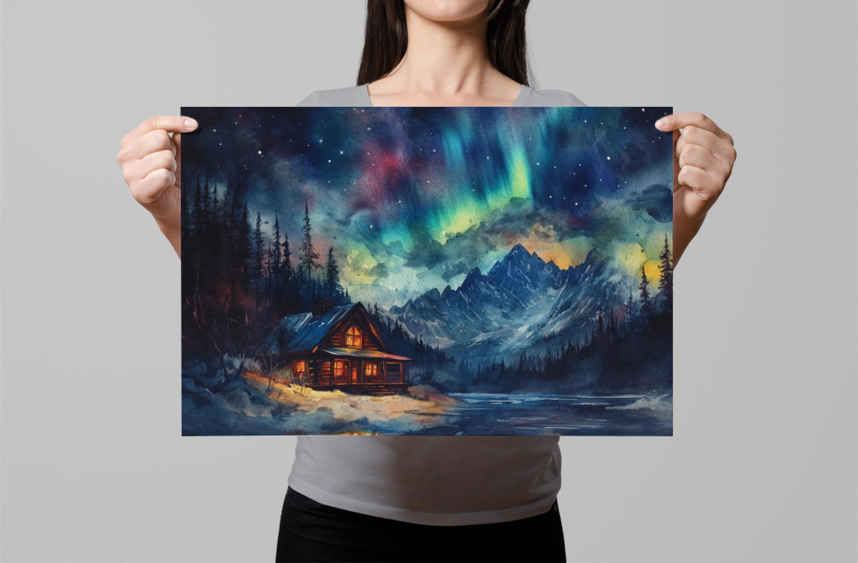 A woman holds up a framed painting depicting a cabin in a snowy mountain landscape with a starry night sky and the northern lights.