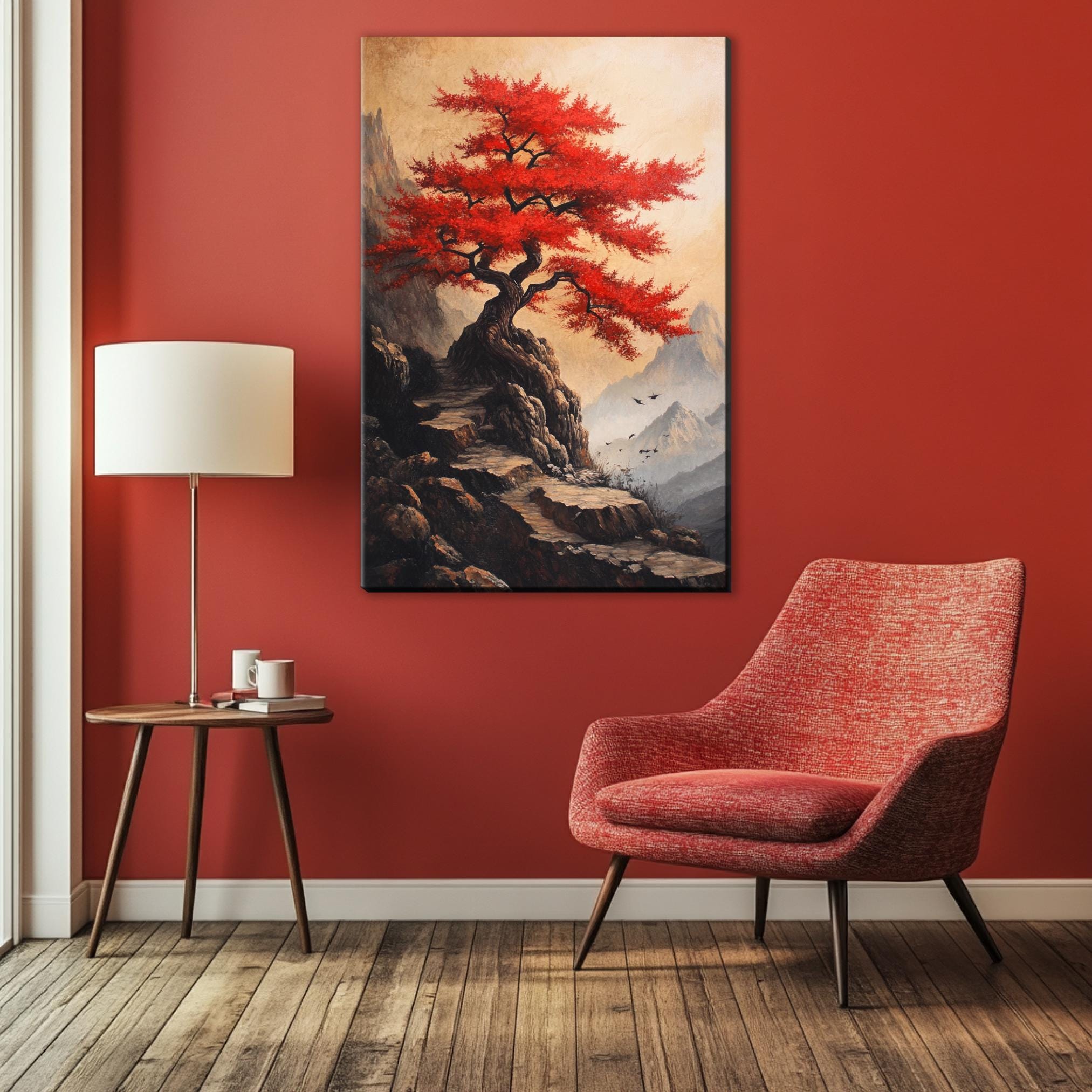 a red chair sitting in front of a painting on a wall