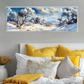 a painting of a snowy landscape on a wall above a bed