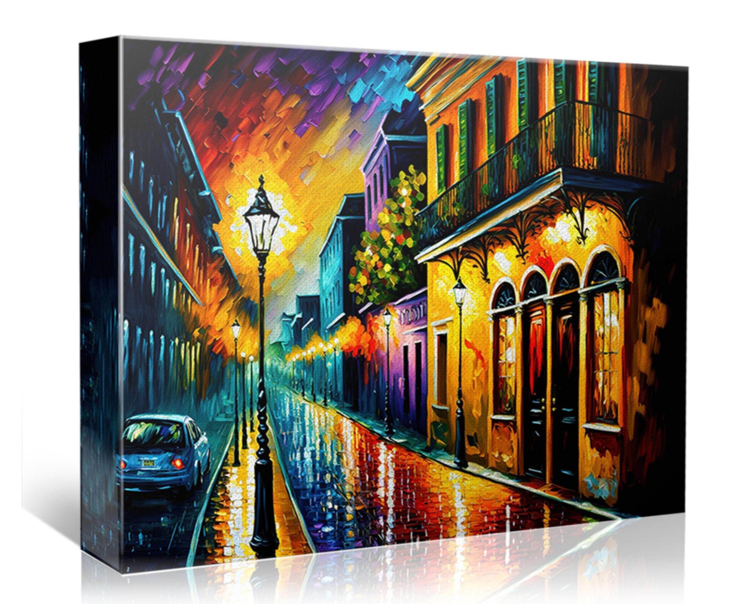 The image is a vibrant painting depicting a lively city street at night, with colorful buildings, a car, and a street lamp casting a warm glow on the wet pavement.