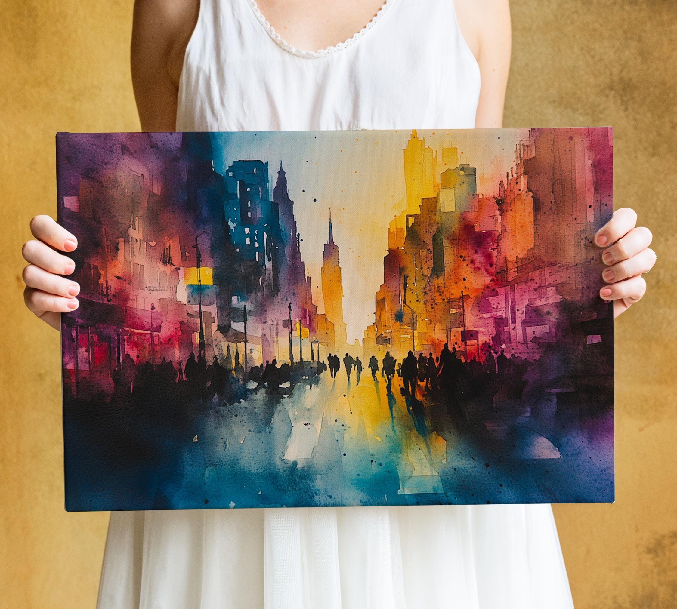 A person is holding up a colorful painting depicting a vibrant cityscape with tall buildings and a busy street scene.