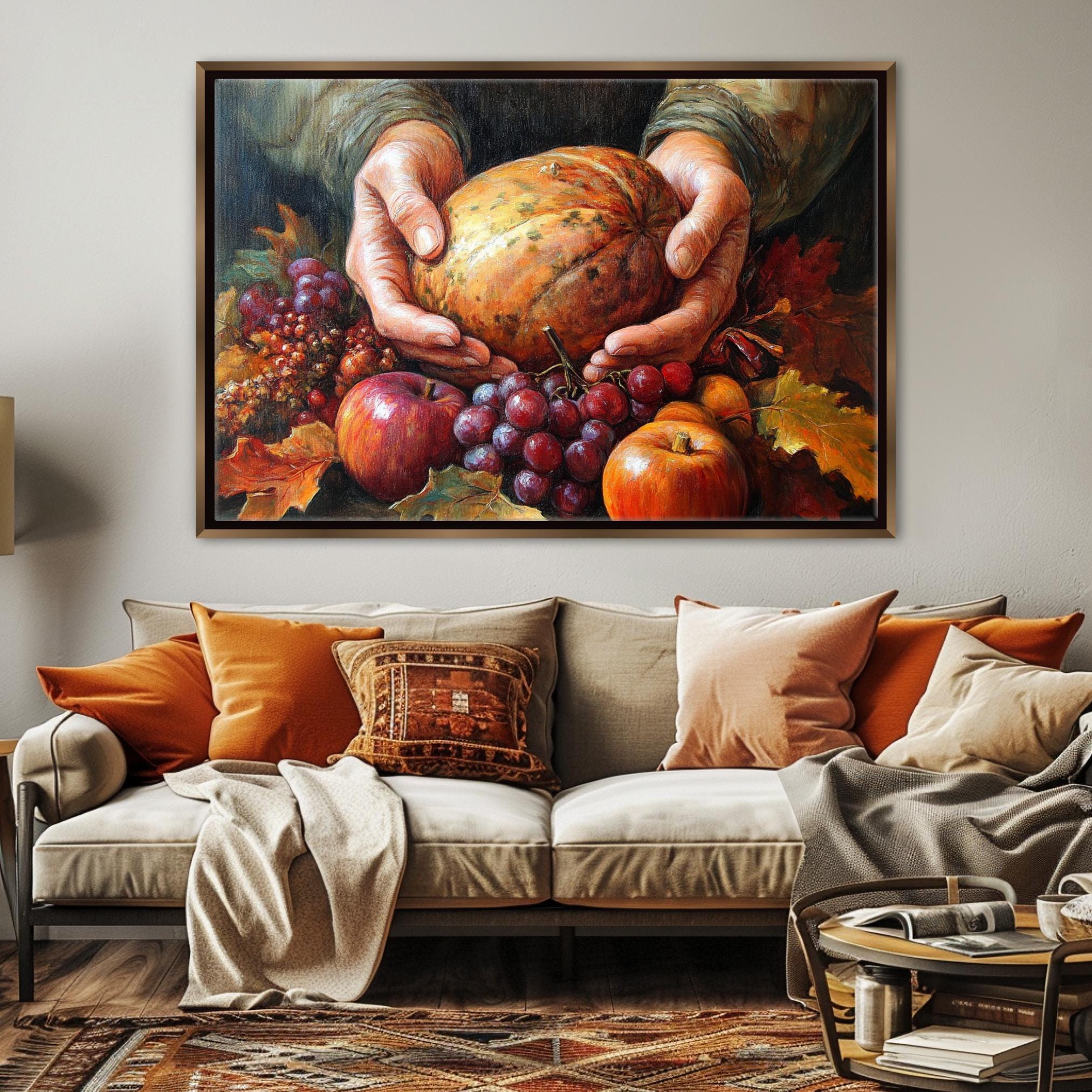 A cozy living room with a large painting of a hand holding a pumpkin surrounded by various fruits, including apples, grapes, and an orange, hanging on the wall above a beige sofa with orange and beige throw pillows.