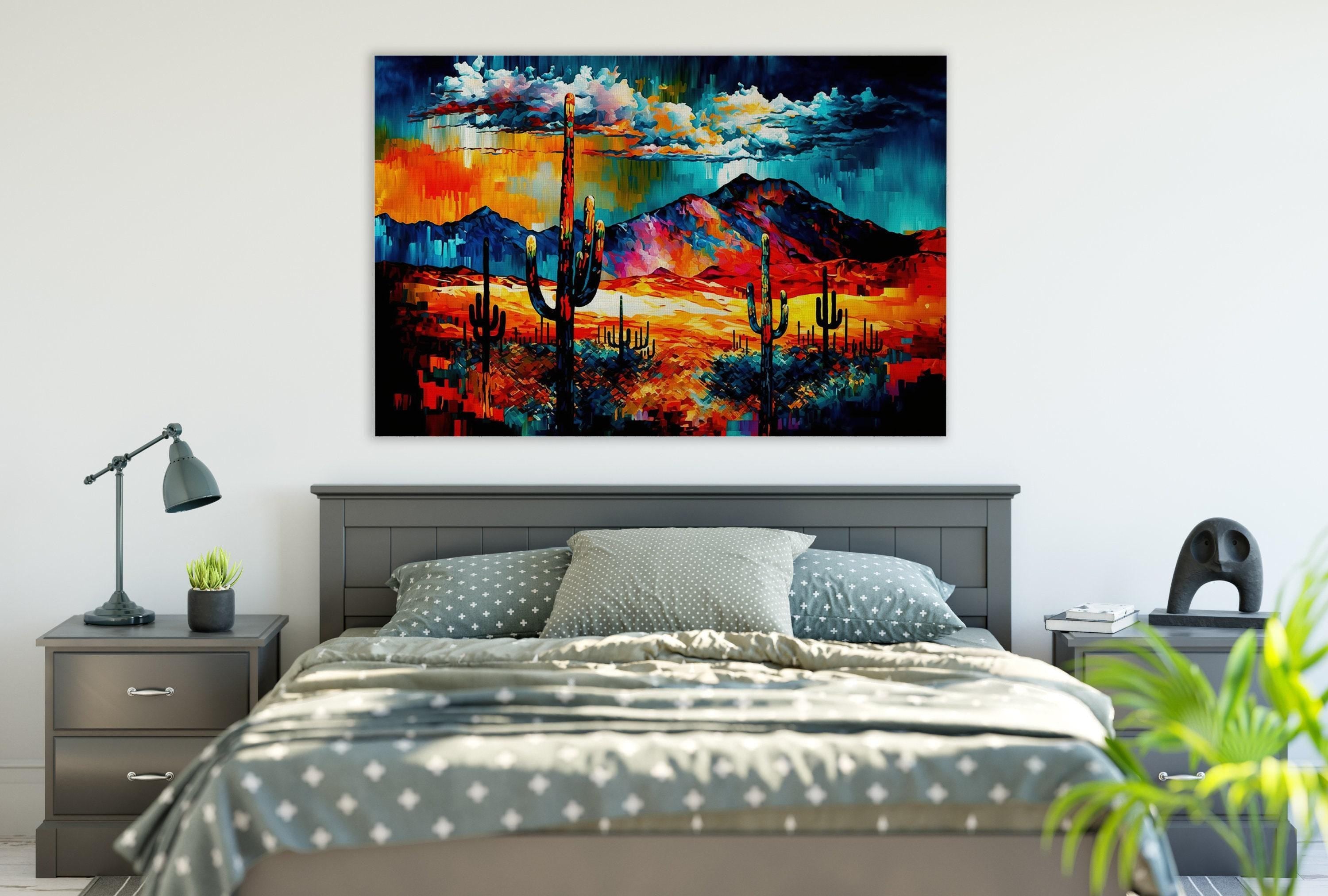 a bedroom with a large, colorful painting of a desert landscape hanging on the wall above a bed with a gray and white patterned bedspread.
