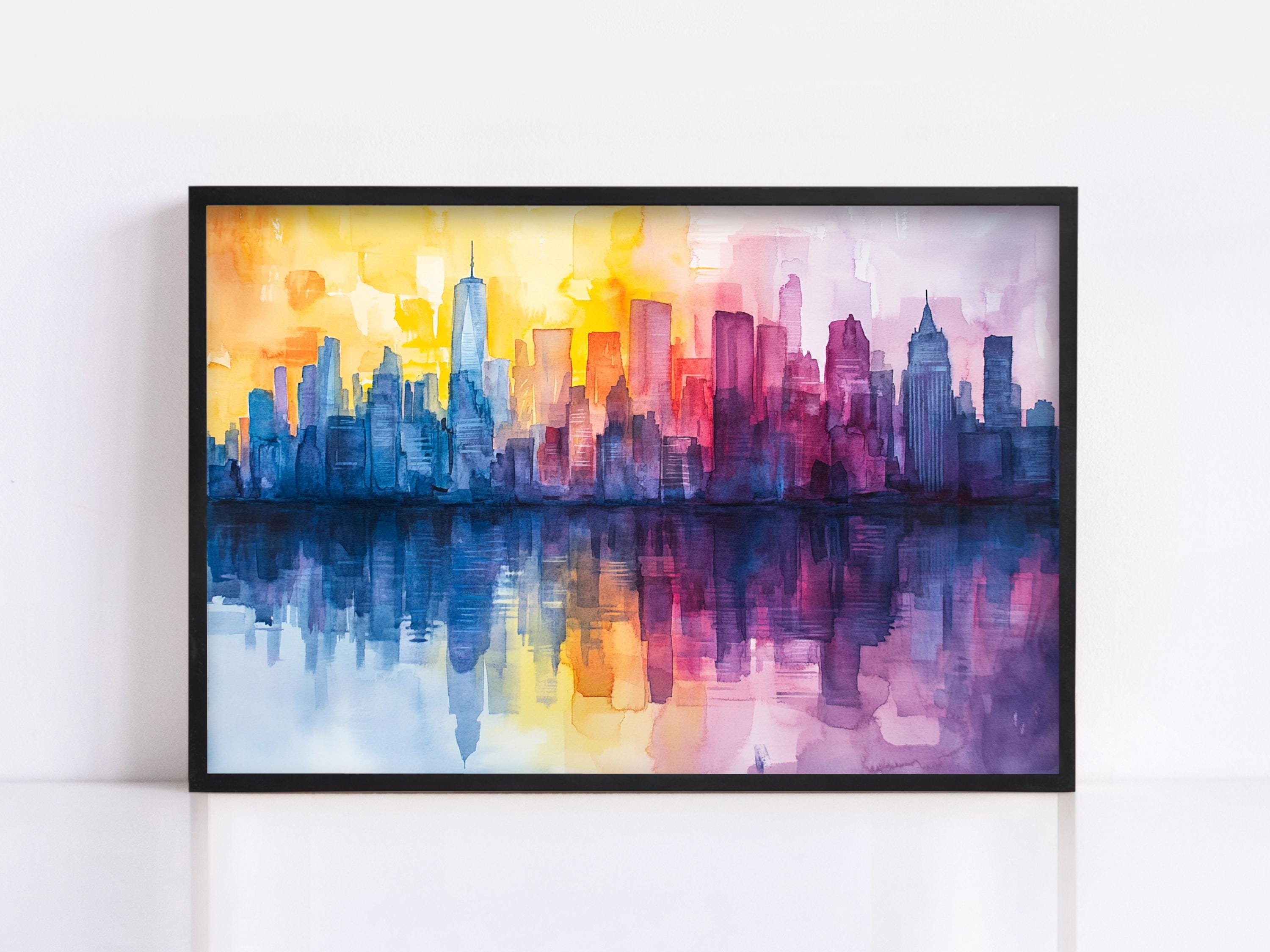 A framed watercolor painting depicting a vibrant cityscape with a reflection of the city skyline in the water below.