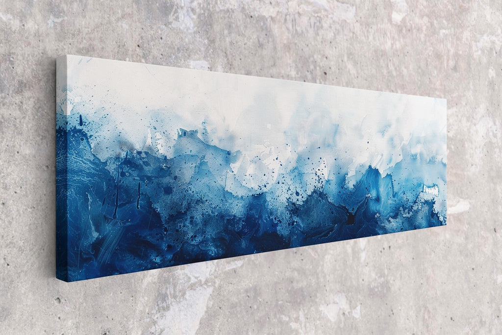 a blue and white painting hanging on a wall