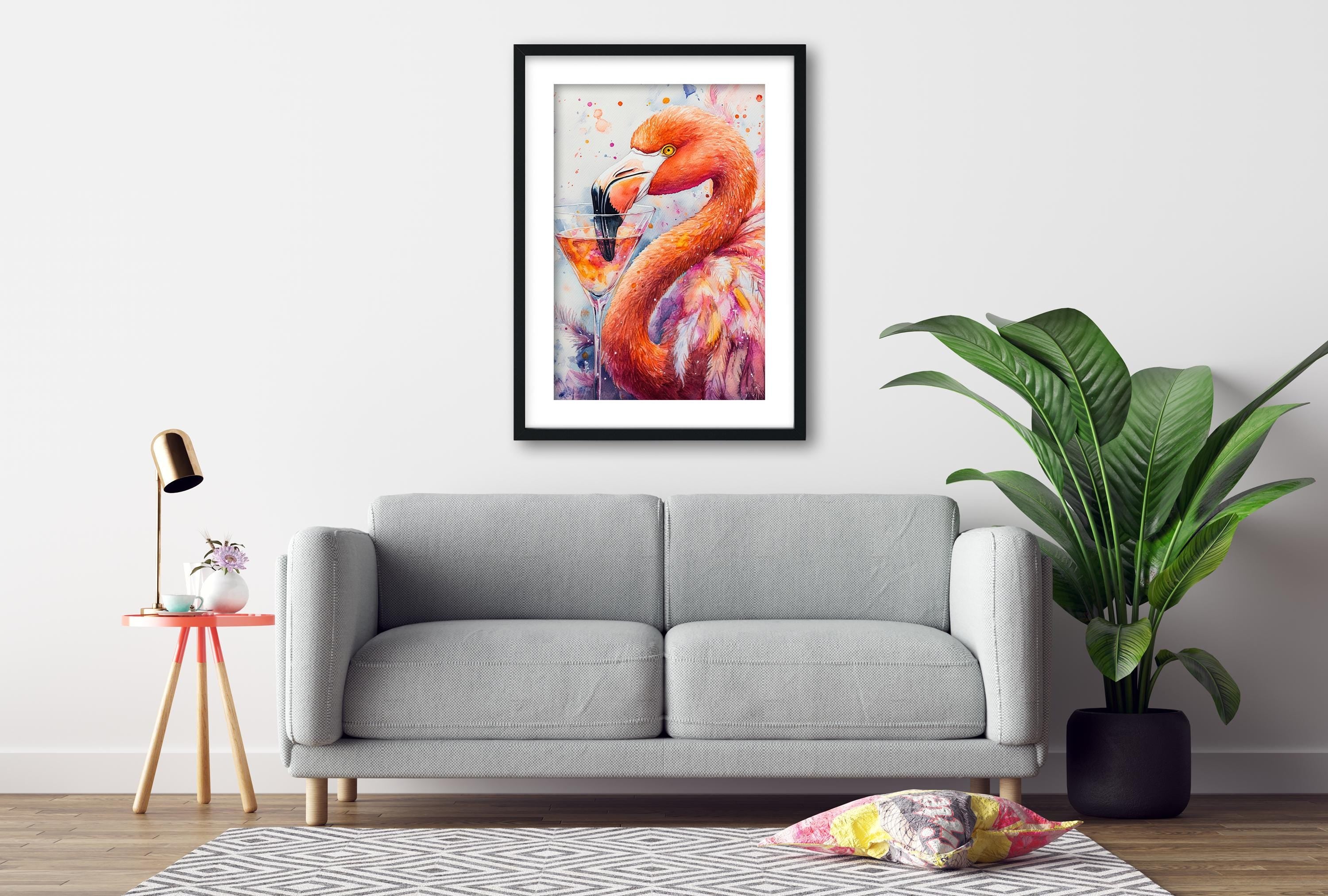 a gray sofa, a framed painting of a flamingo, a small table with a lamp, and a potted plant, all arranged in a living room setting.