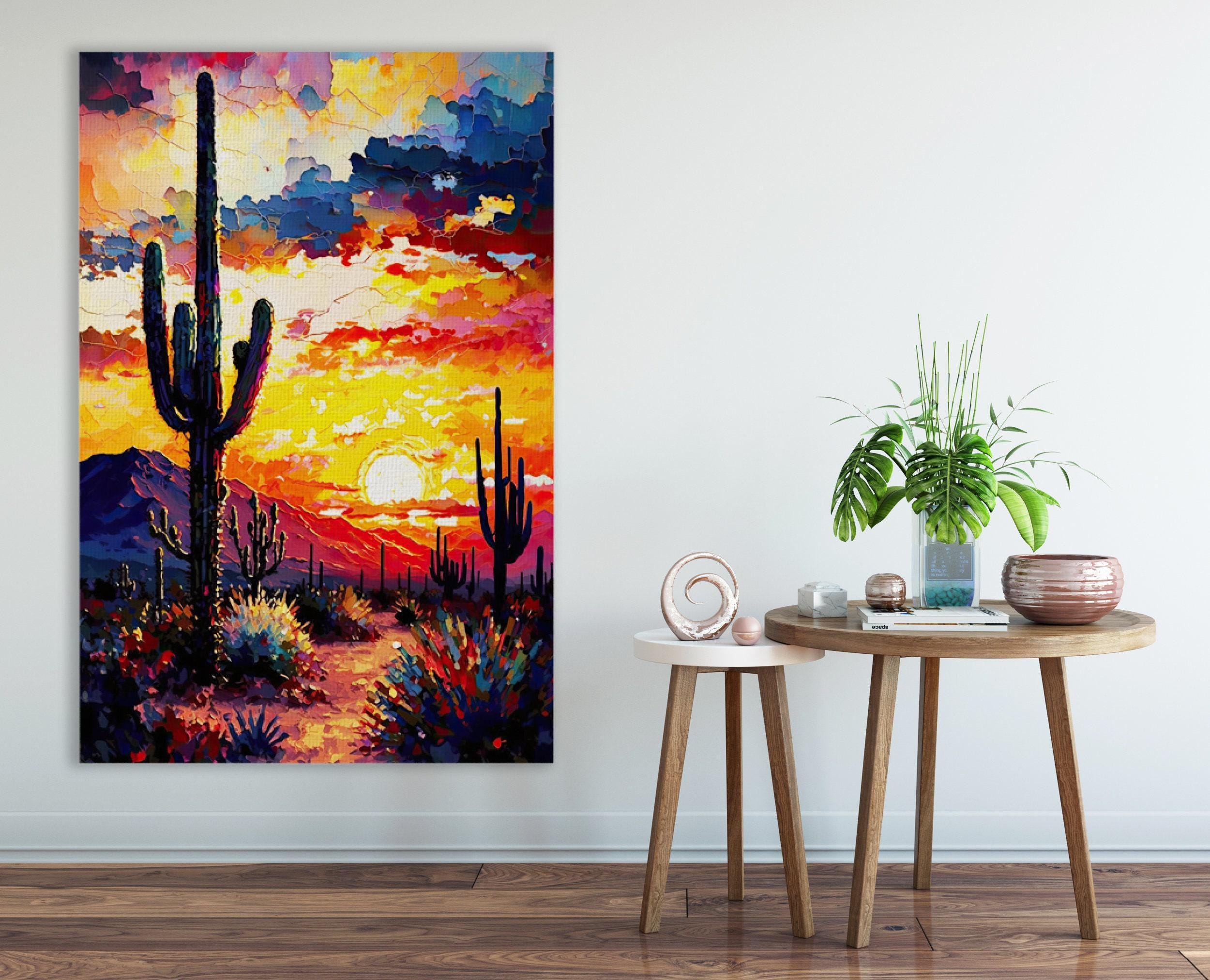 a vibrant desert landscape with a cactus and a sunset in the background, as well as a table with a plant and a small sculpture on it.