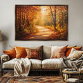 a large painting of a forest path with autumn foliage hanging on a wall above a beige sofa adorned with orange and beige throw pillows.
