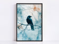 A black bird perches on a branch, facing right, with a blurred background of trees and foliage.