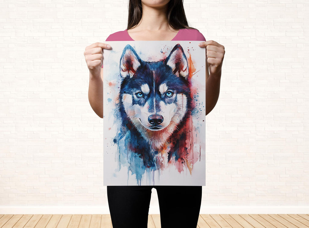 A woman is holding up a poster featuring a close-up of a wolf's face with blue eyes and a black and white color scheme.