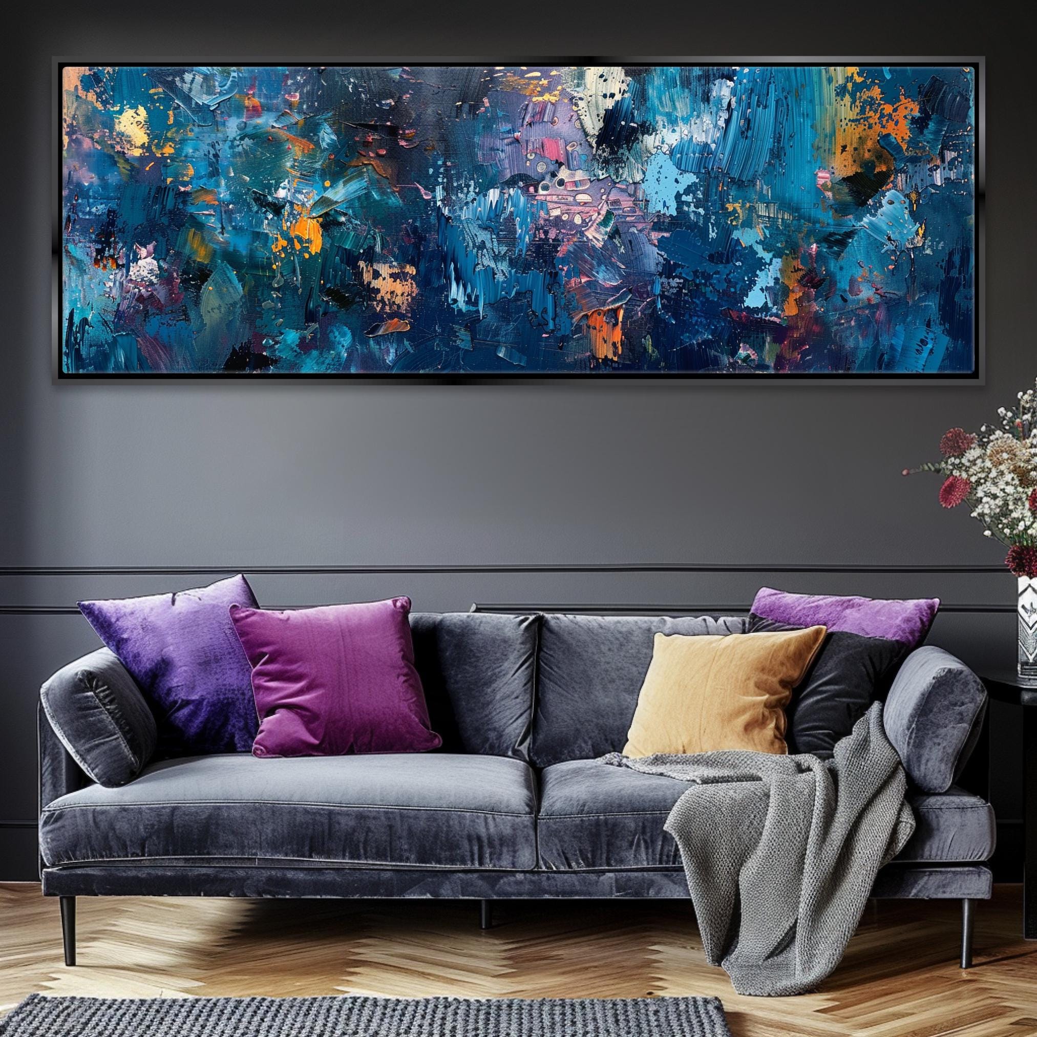 a living room with a couch and a painting on the wall