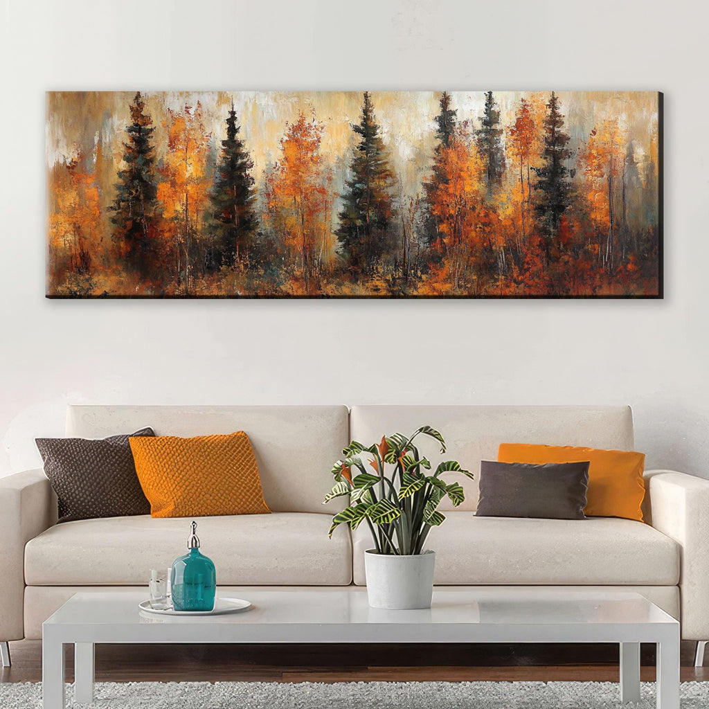 a large painting of a forest scene with tall trees in autumn colors, hanging on a wall above a white sofa with colorful throw pillows.