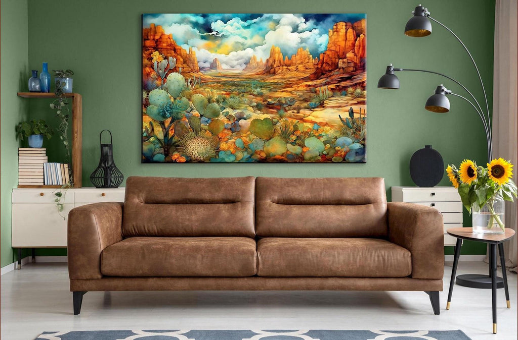 a large, colorful painting of a desert landscape hanging on a wall in a living room. The painting depicts a desert scene with cacti, mountains, and a cloudy sky. The room has a brown leather sofa, a side table with a vase of flowers, and a floor lamp.