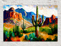 A vibrant, colorful painting depicting a desert landscape with towering mountains, cacti, and a bright blue sky with fluffy clouds.