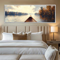 a painting of a boat on a lake hangs above a bed