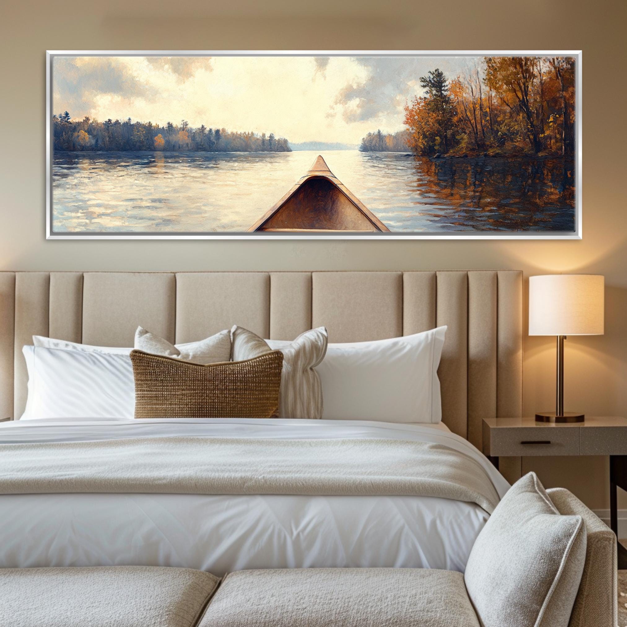 a painting of a boat on a lake hangs above a bed