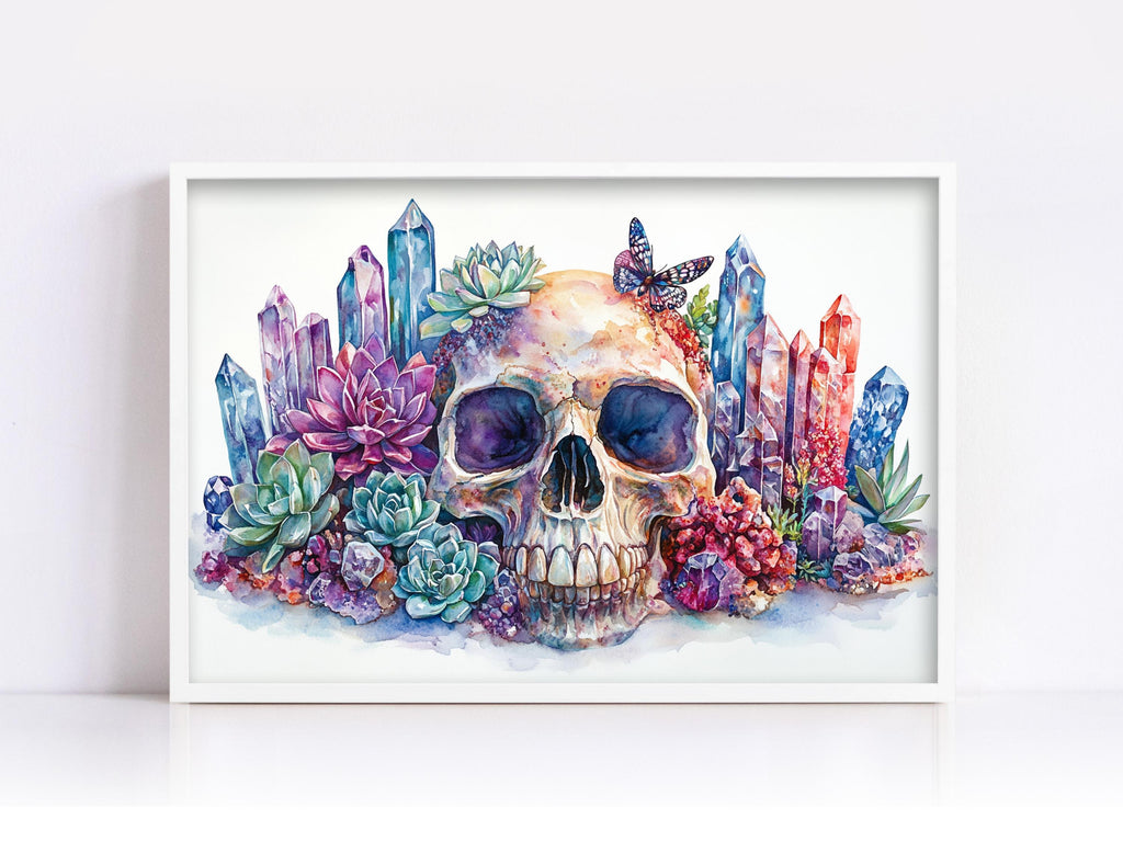A framed watercolor painting depicting a skull surrounded by colorful crystals, succulents, and butterflies.