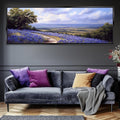 a living room with a couch and a painting on the wall