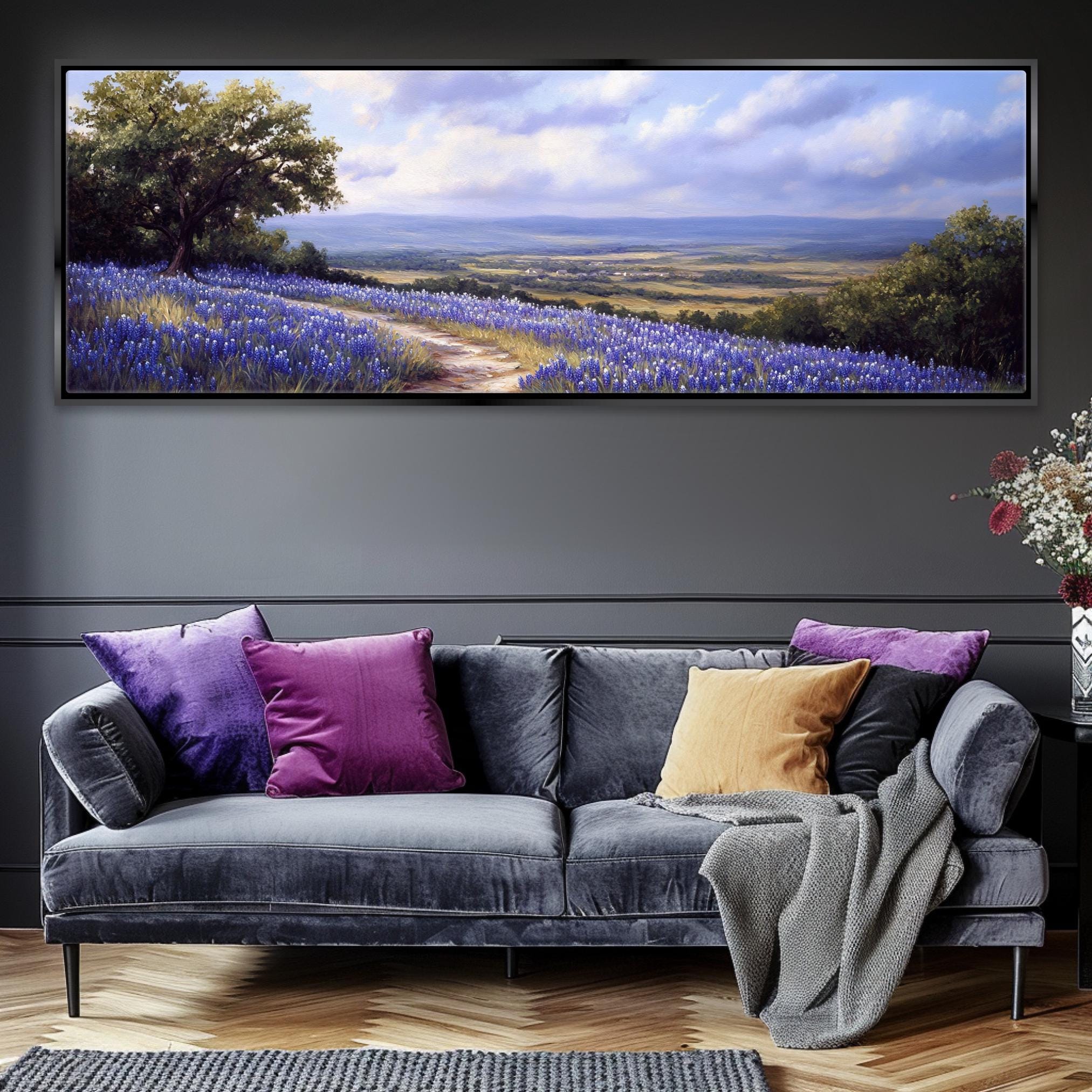 a living room with a couch and a painting on the wall