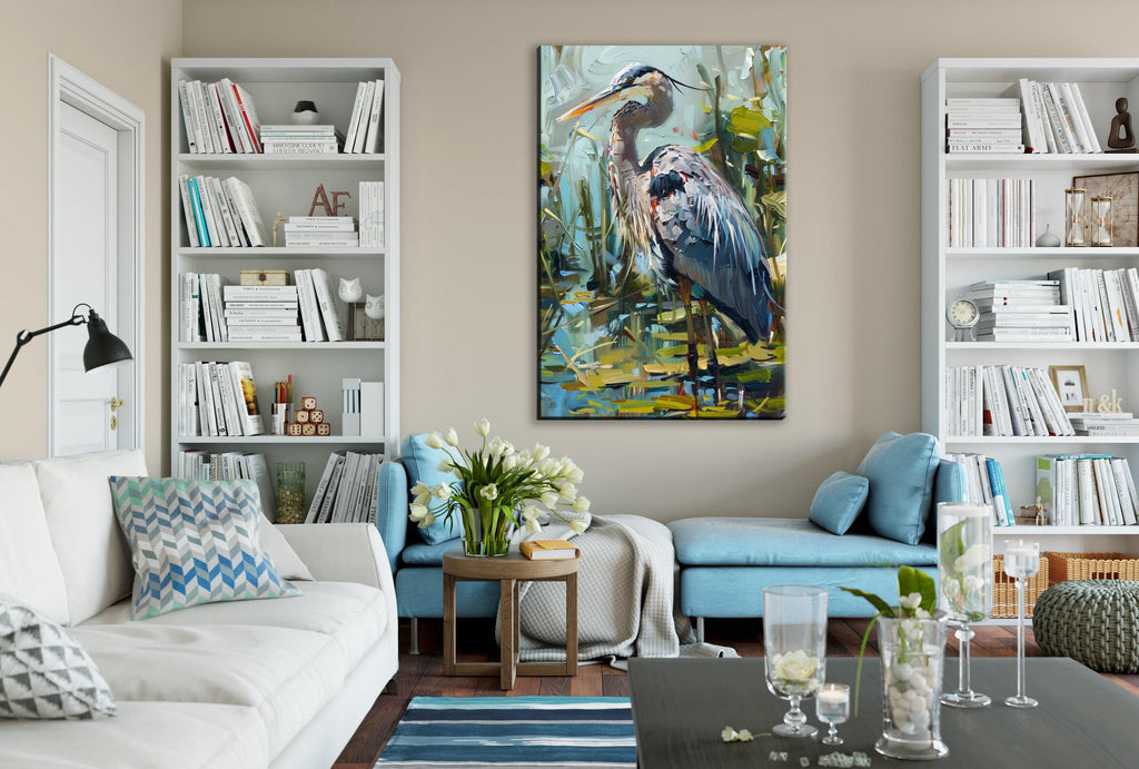 a cozy living room with a large painting of a blue heron on the wall. The room is furnished with a white sofa, a blue armchair, and a wooden coffee table. The walls are decorated with white bookshelves, and the room is illuminated by a lamp. The overall atmosphere of the room is calm and inviting, with a touch of nature represented by the painting of the heron.