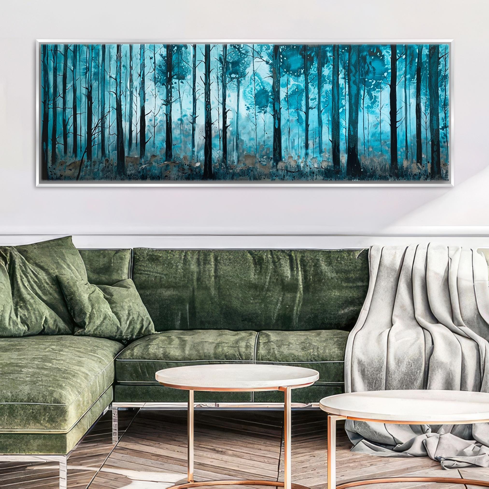 a living room with a green couch and a painting on the wall