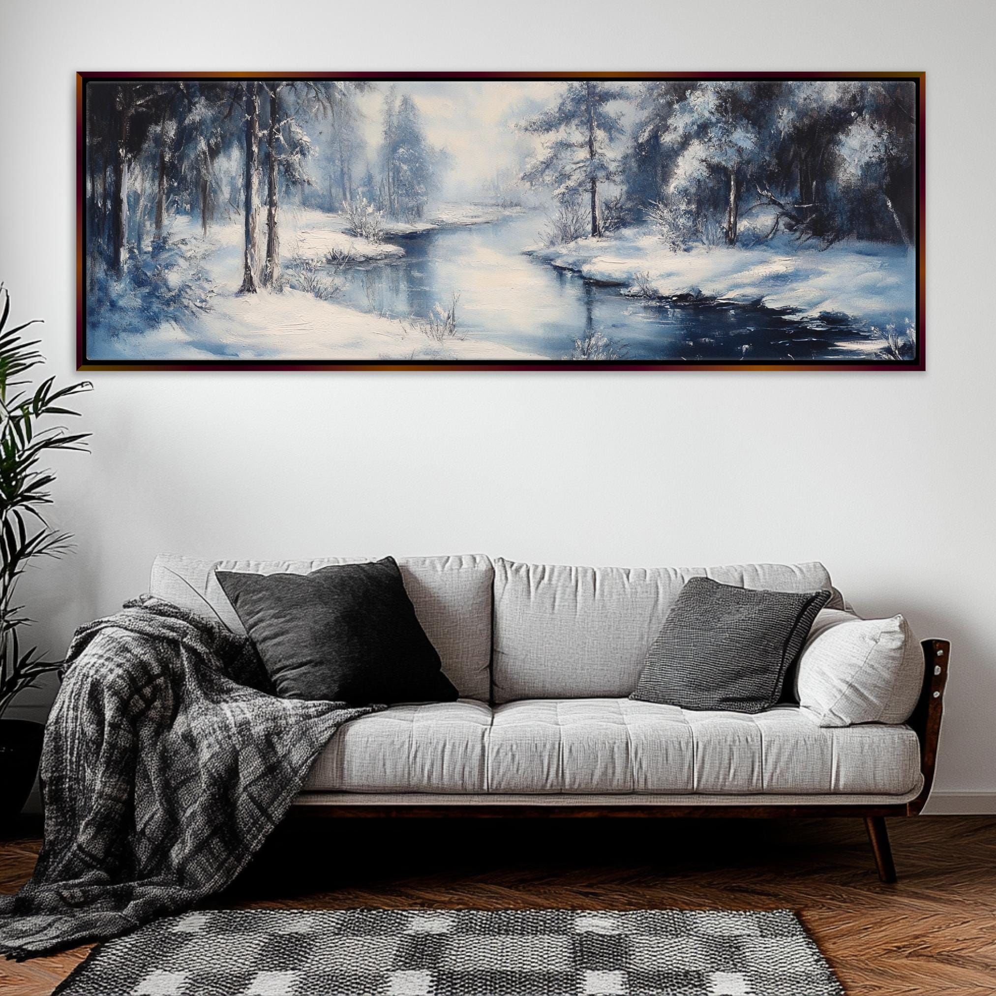 a living room with a couch and a painting on the wall