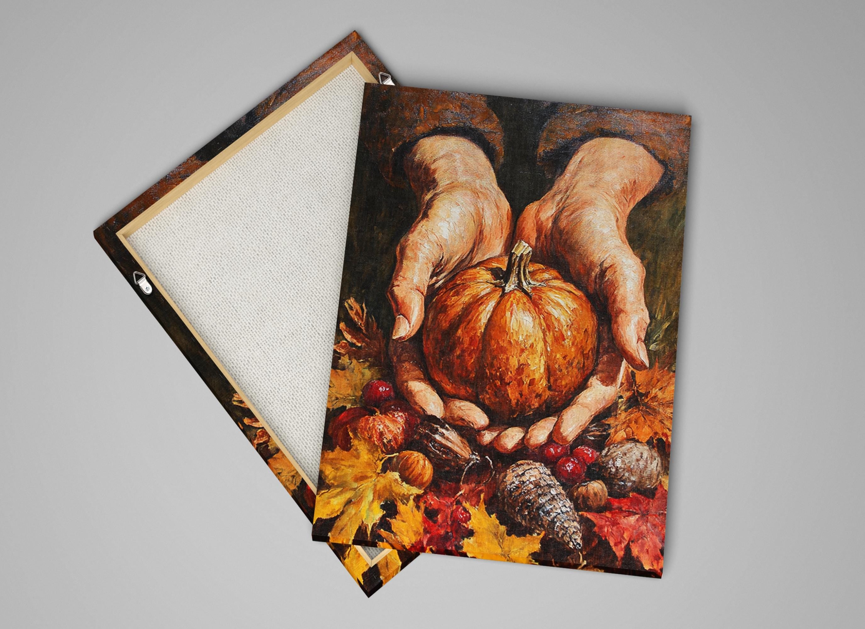 a pair of hands holding a pumpkin, surrounded by autumn leaves and other fall-themed objects.