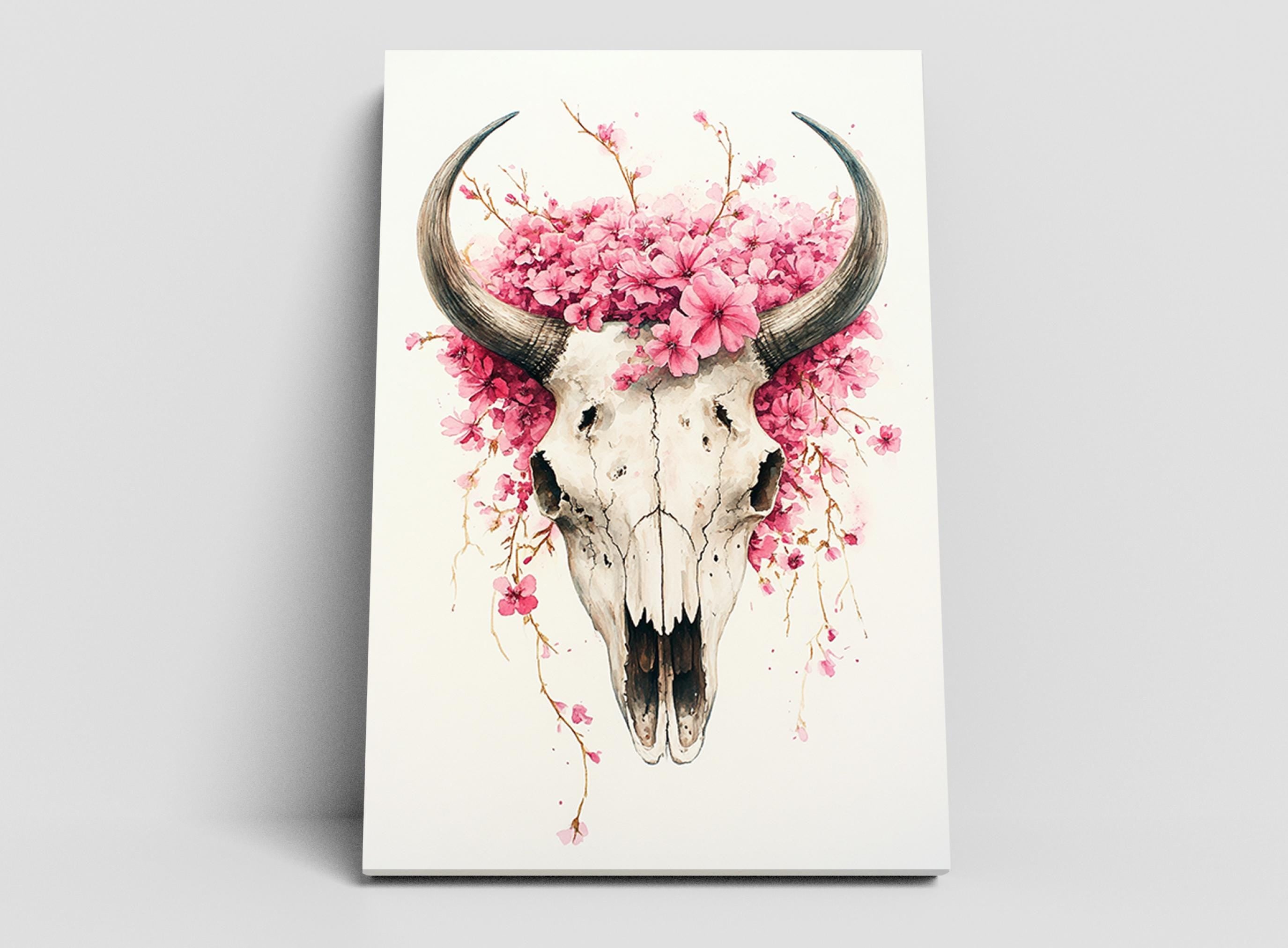 A white skull adorned with pink flowers and branches, creating a striking and visually appealing composition.