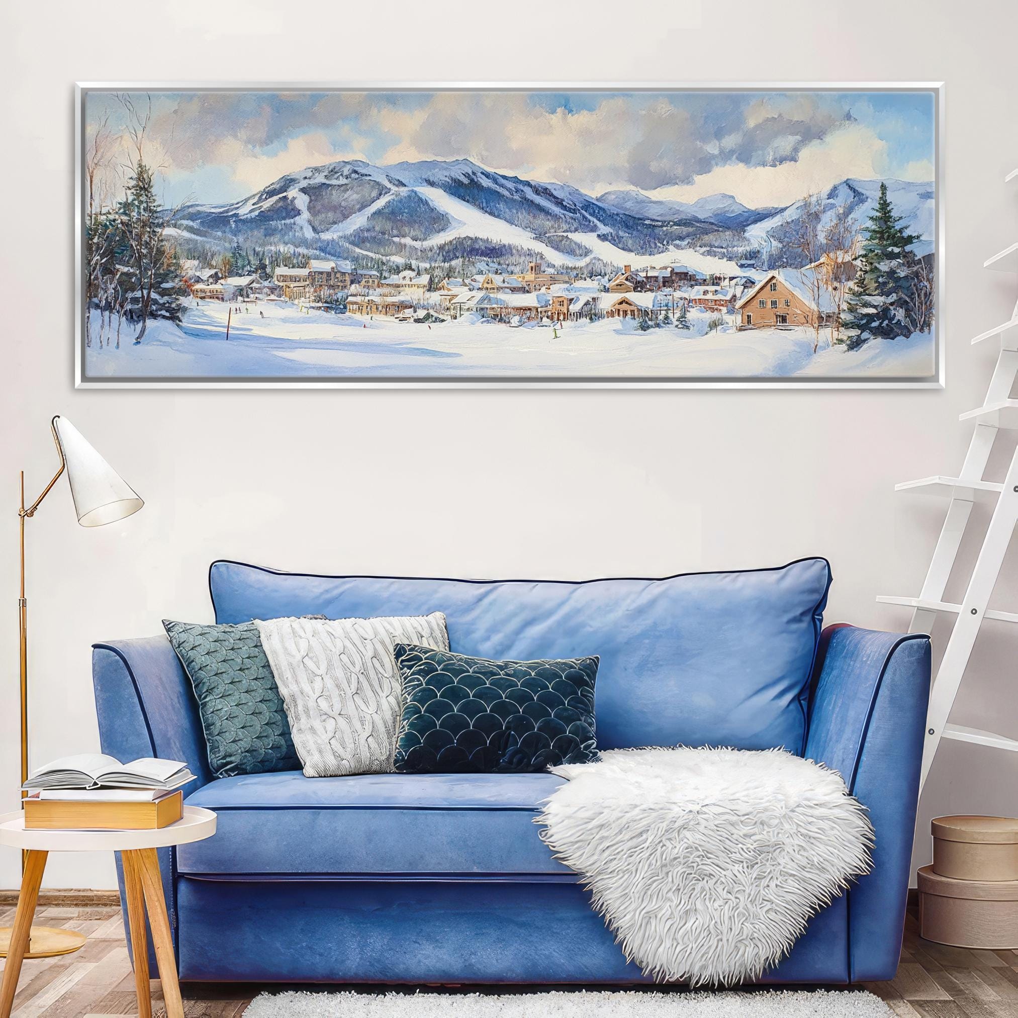 a living room with a blue couch and a painting on the wall