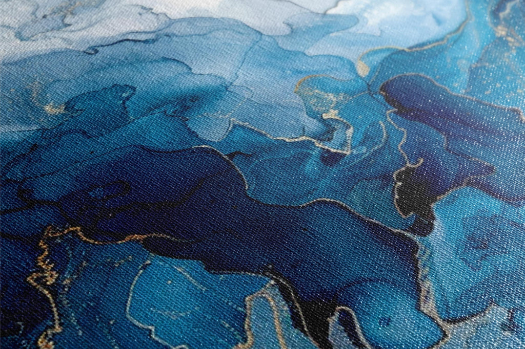 a close up of a painting with blue and gold paint