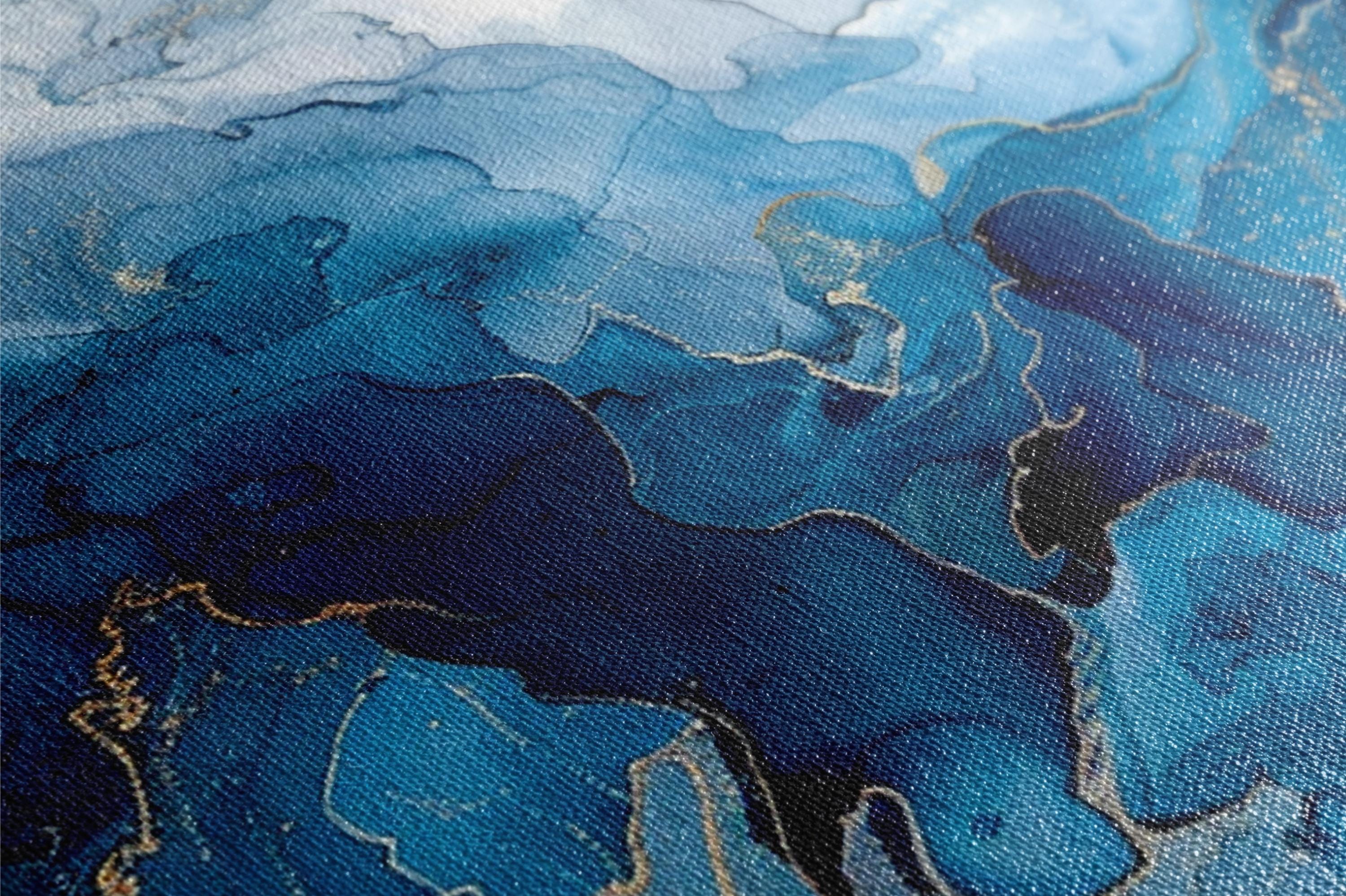 a close up of a painting with blue and gold paint