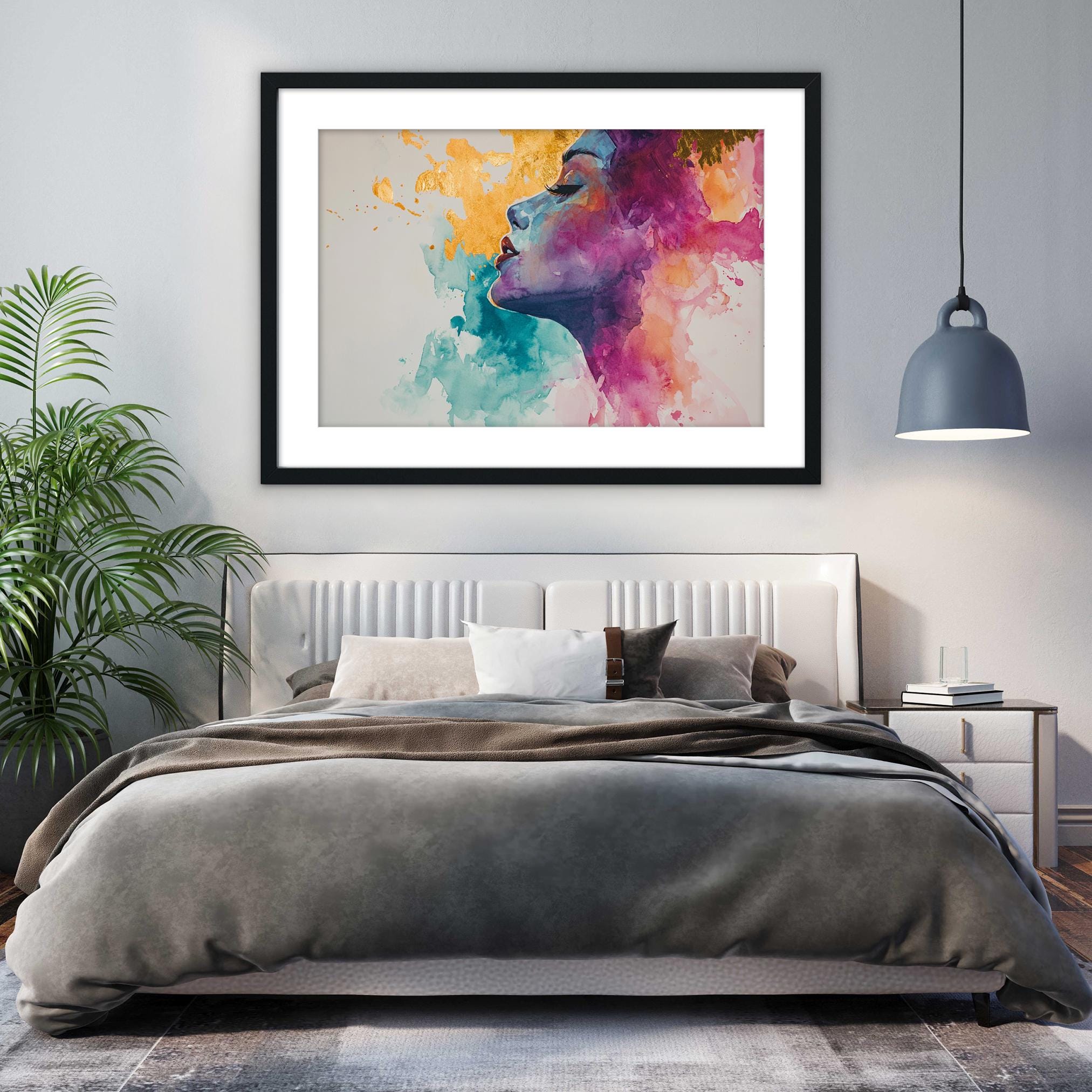 a modern bedroom with a large bed, a framed colorful painting of a woman's face hanging above it, and a potted plant to the left.
