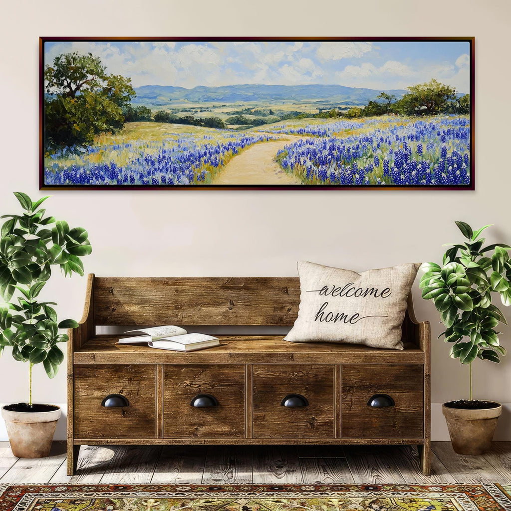 a painting of a field of bluebonnets hangs above a bench