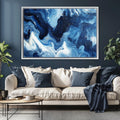 a living room with a couch and a painting on the wall