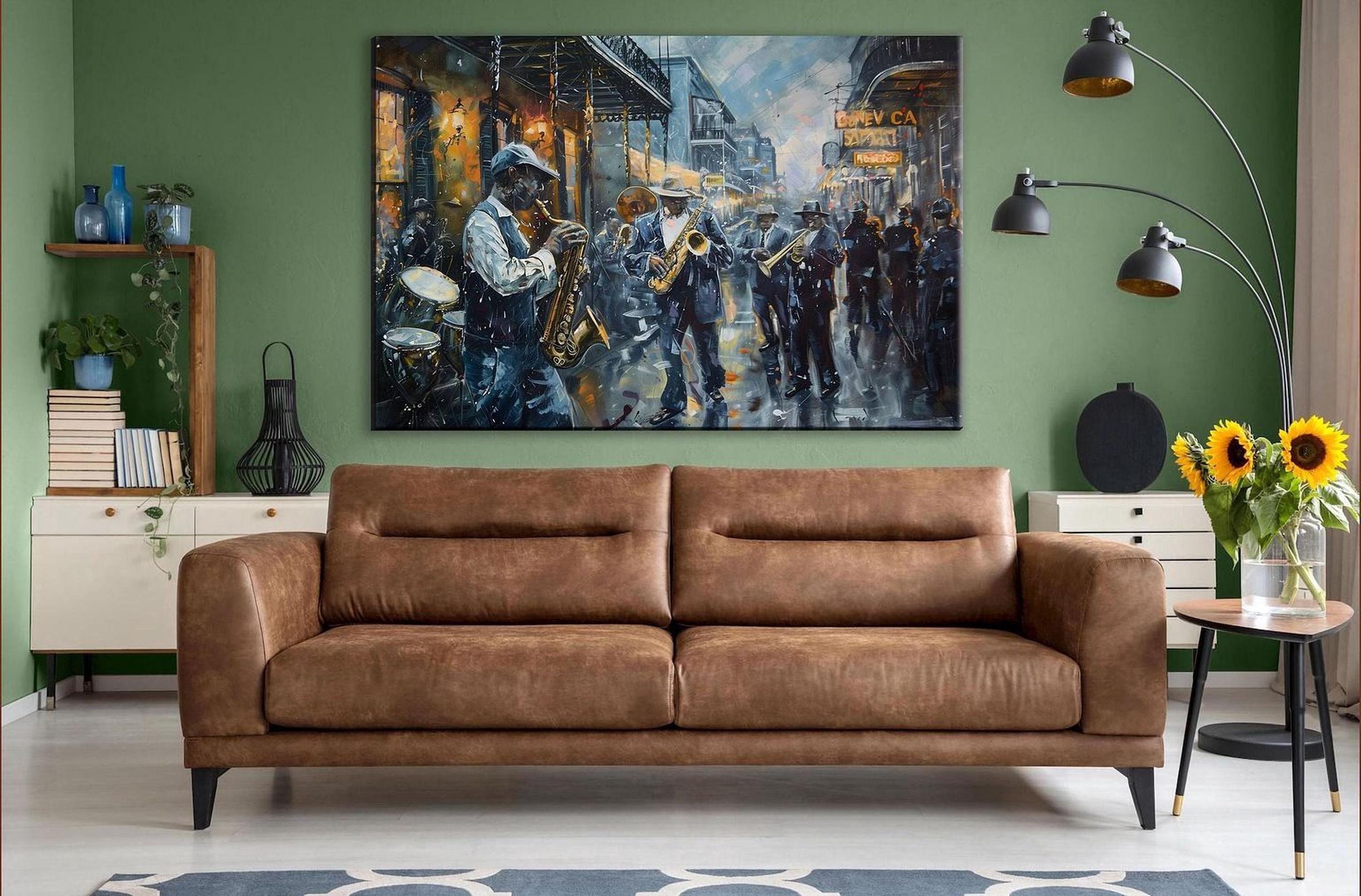 a large painting of a street scene with a group of people playing musical instruments, such as saxophones and drums, in the background. The painting is displayed on a green wall above a brown leather couch in a living room setting.