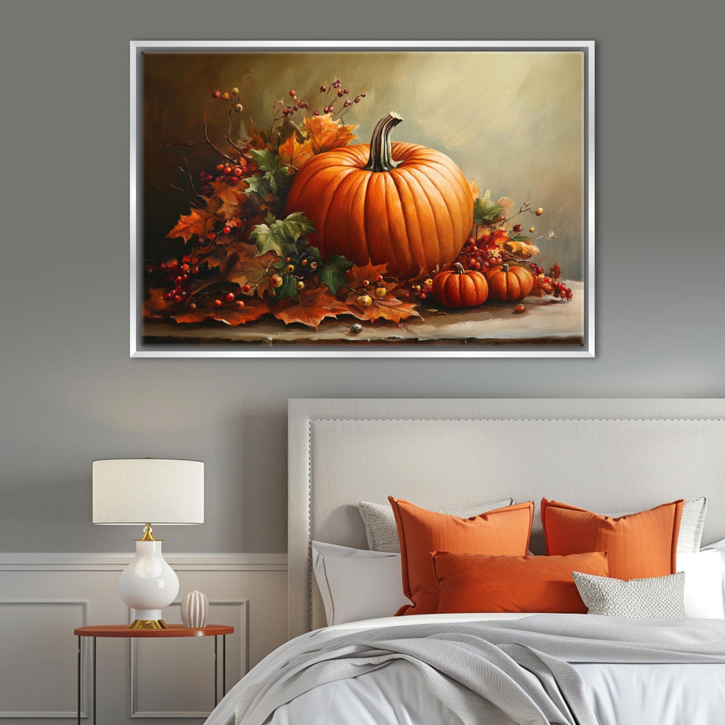 a large framed painting of a pumpkin and autumn leaves on a wall above a bed with orange pillows and a white headboard.