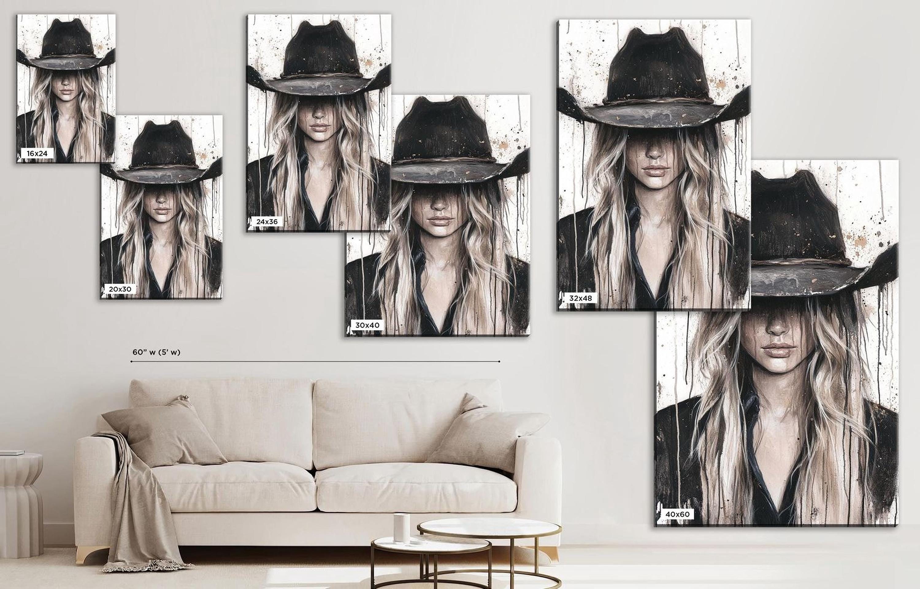 a living room with a couch and a wall mounted picture of a woman wearing a