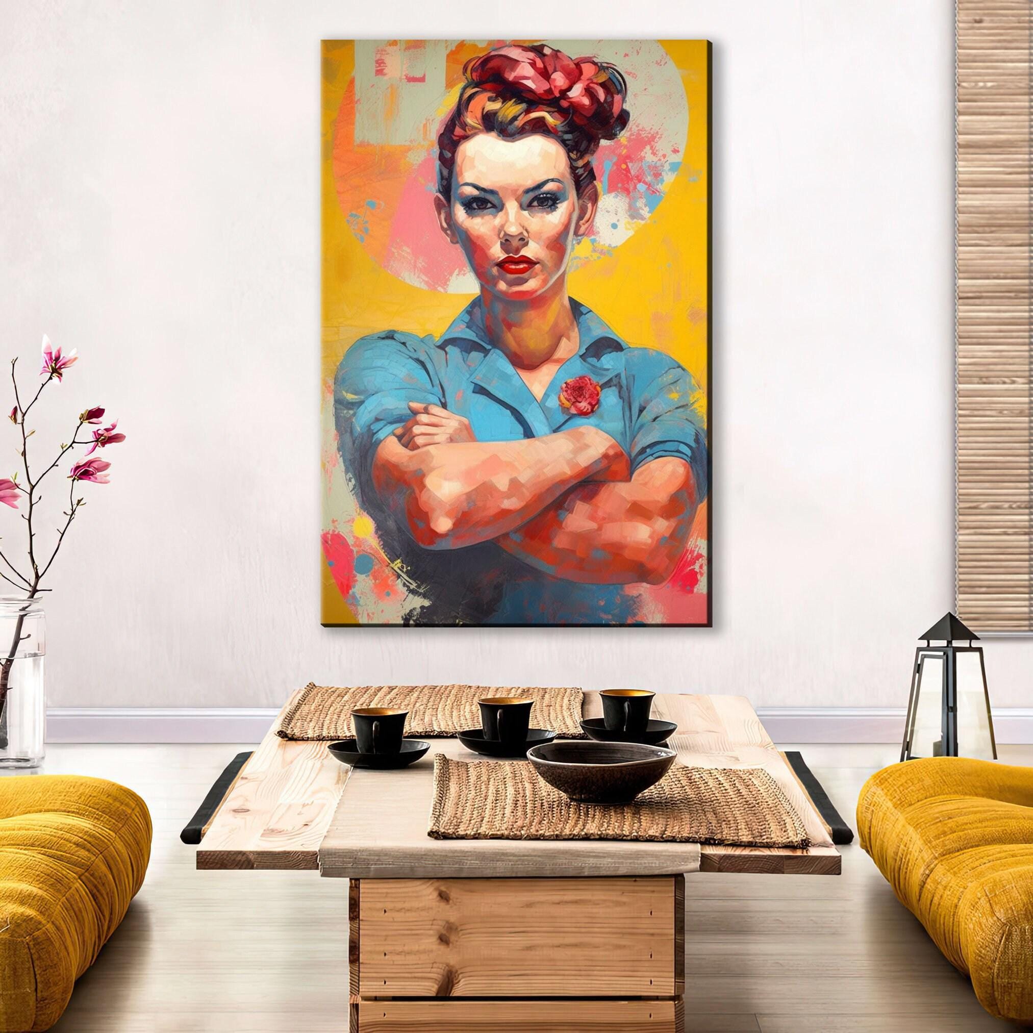 a large, colorful painting of a woman with her arms crossed, hanging on a wall above a wooden coffee table.