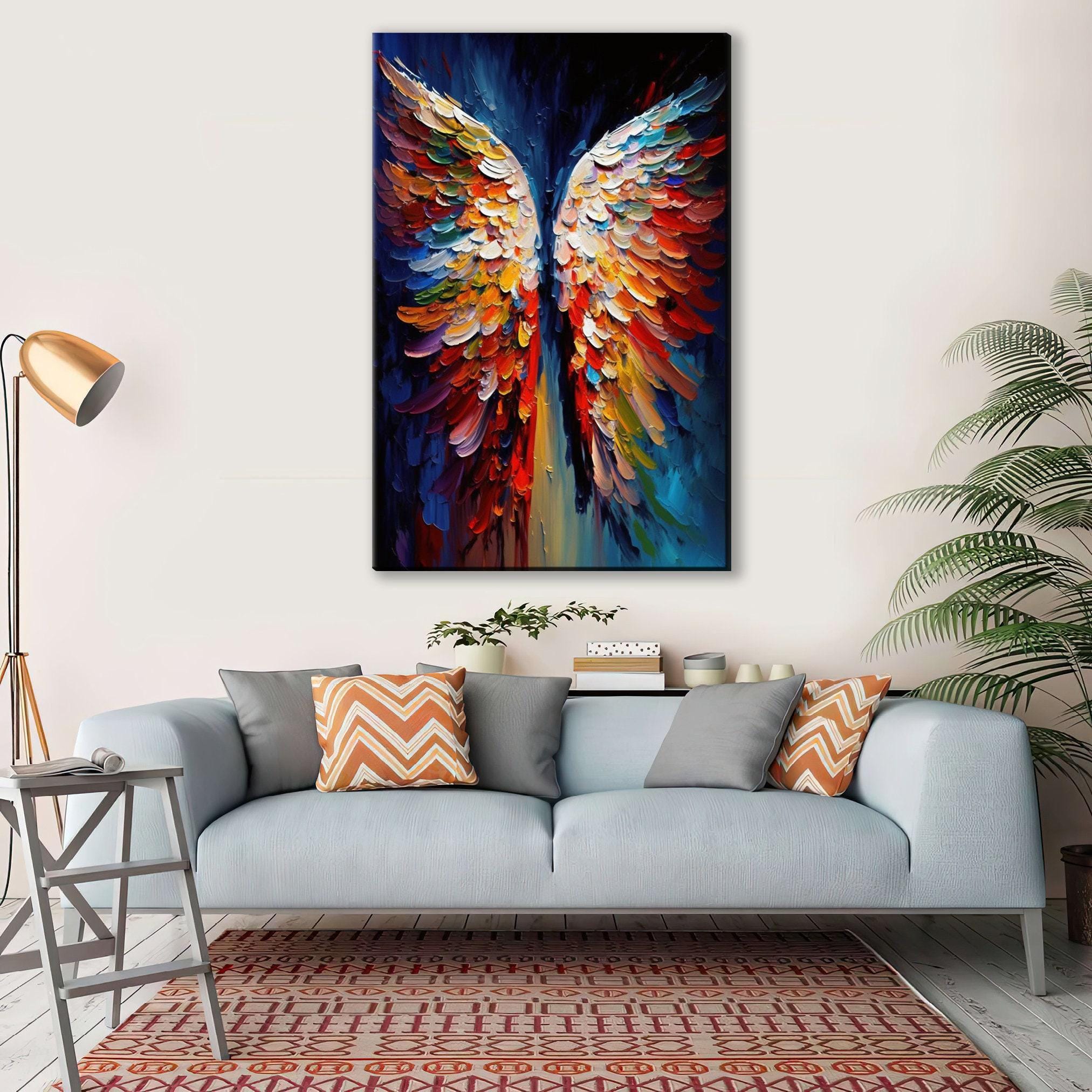 a large, colorful painting of a pair of vibrant, multicolored wings hanging on the wall above a gray couch with patterned throw pillows.