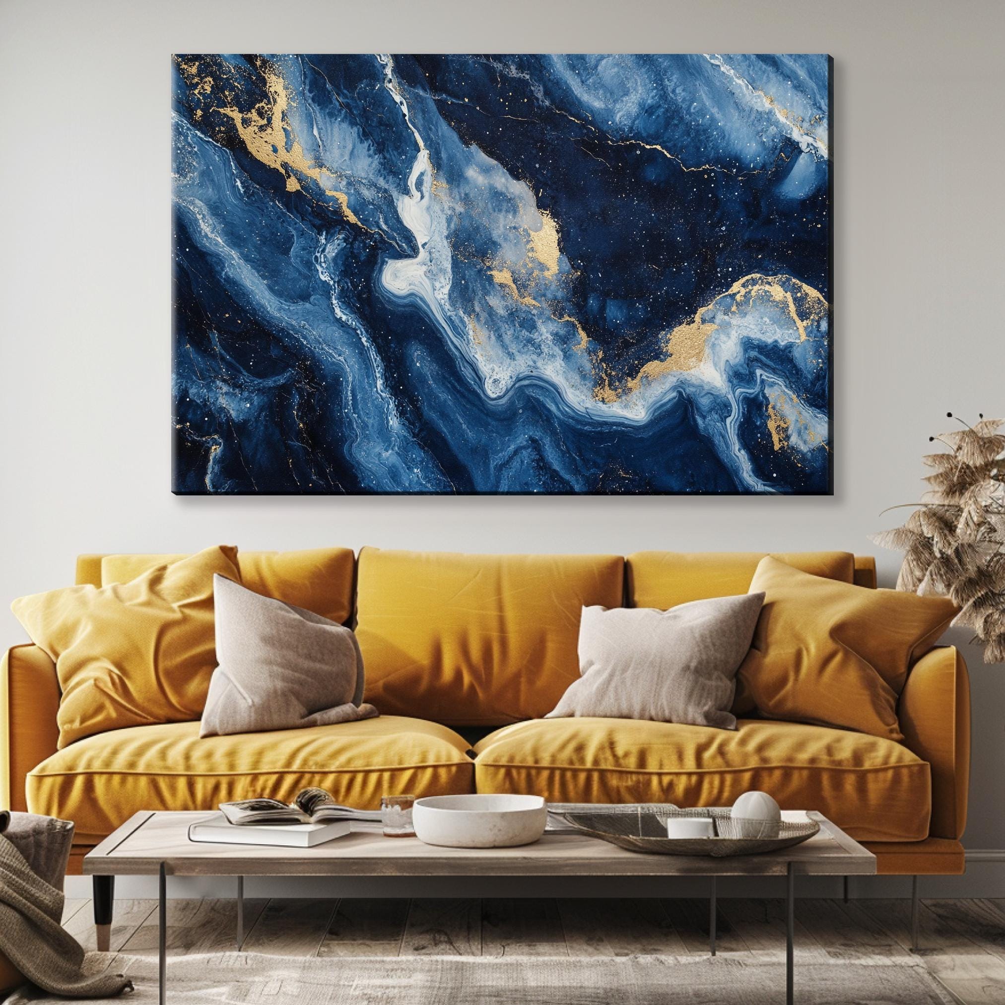 a living room with a yellow couch and a large painting on the wall